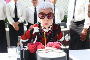 Iris Apfel celebrates her birthday at the IRIS x INC debut with a cake her face in emoji form. Photography courtesy of BFA.
